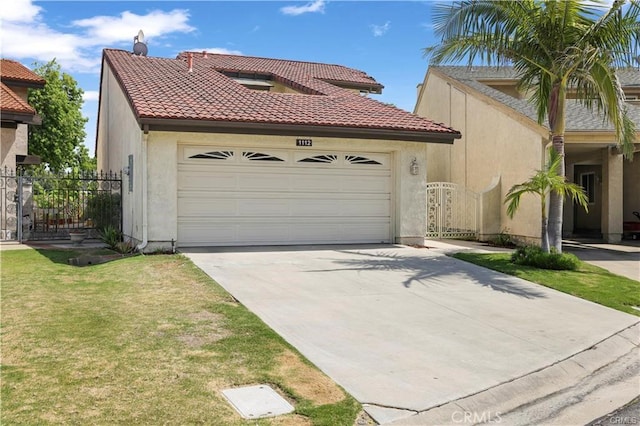 mediterranean / spanish home with a front yard and a garage