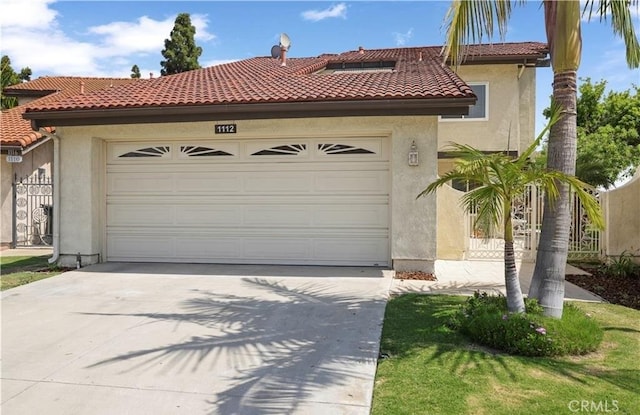 mediterranean / spanish-style home with a garage