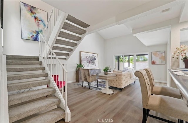 living room with lofted ceiling and wood-type flooring