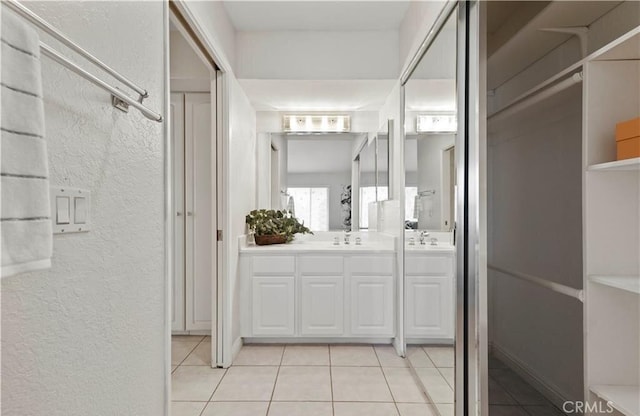 bathroom with tile patterned flooring and vanity