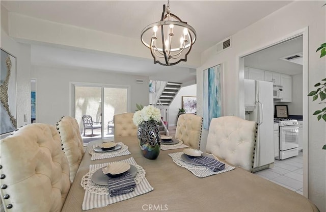 tiled dining space with a notable chandelier