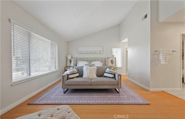 bedroom with hardwood / wood-style floors and high vaulted ceiling