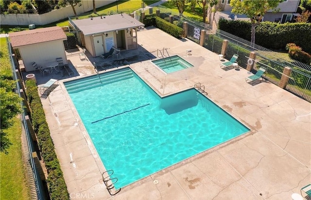 view of swimming pool featuring a community hot tub and a patio