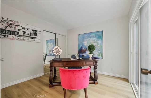 home office with light hardwood / wood-style floors