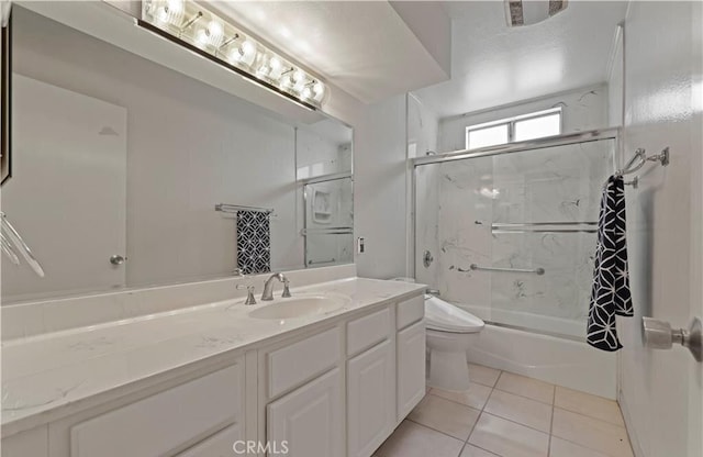 full bathroom featuring tile patterned flooring, vanity, toilet, and enclosed tub / shower combo