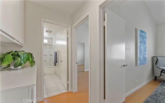 corridor with light hardwood / wood-style floors