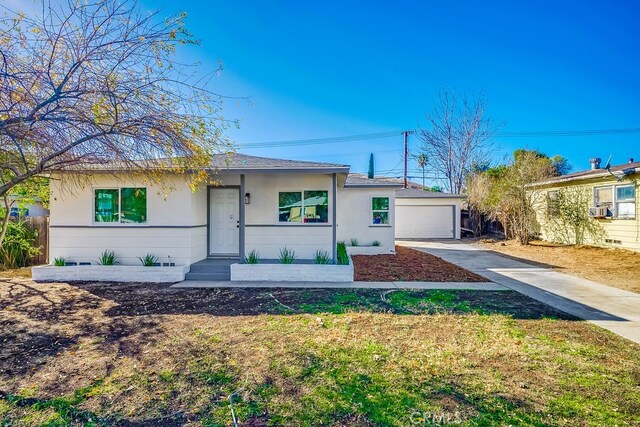 ranch-style house featuring an outbuilding, cooling unit, and a garage