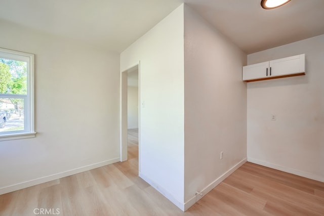 interior space featuring light wood-style flooring and baseboards