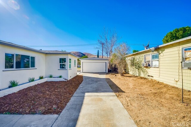 view of home's exterior with a garage and an outdoor structure