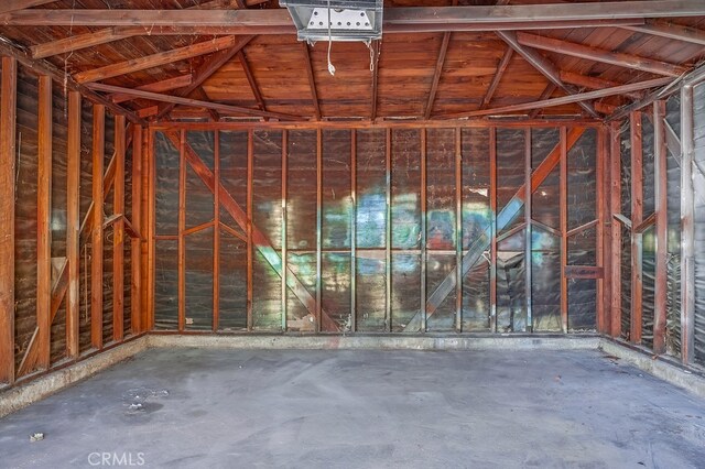 misc room with concrete floors and lofted ceiling