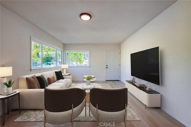 living room featuring light wood-type flooring and baseboards