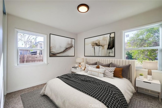 bedroom featuring multiple windows and baseboards