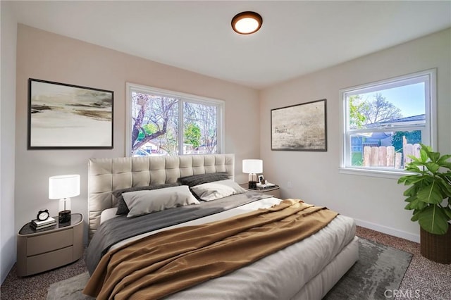 carpeted bedroom featuring baseboards
