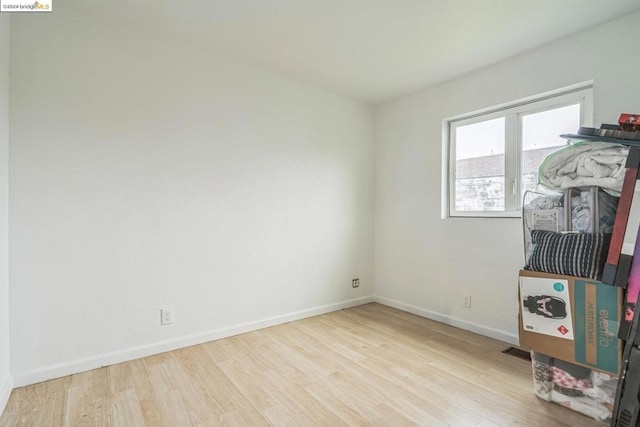 empty room with light hardwood / wood-style flooring