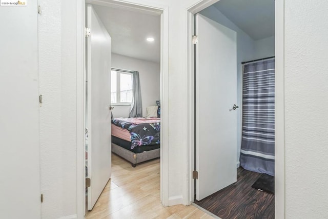 hallway with light hardwood / wood-style flooring