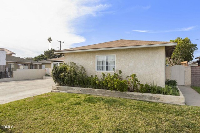 view of side of home with a lawn