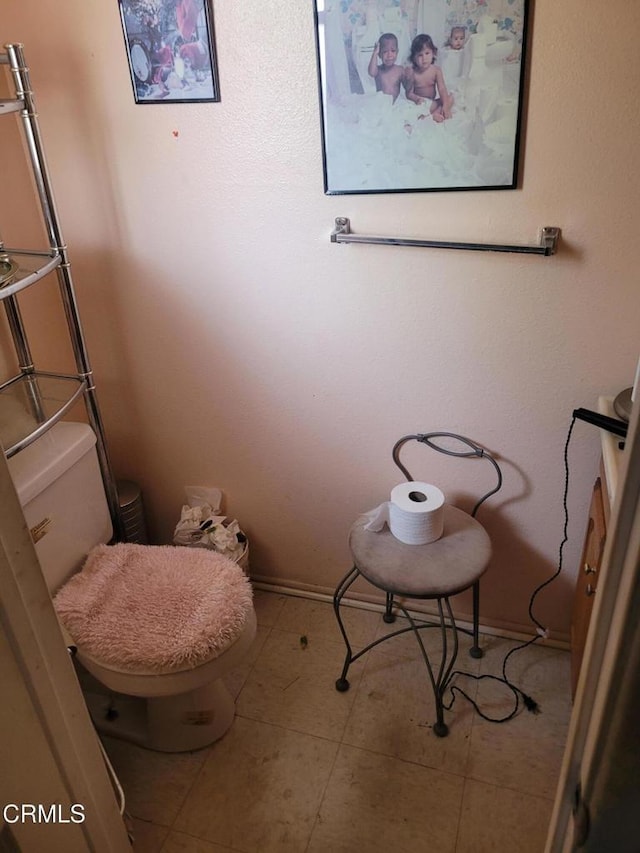 bathroom featuring tile patterned flooring and toilet