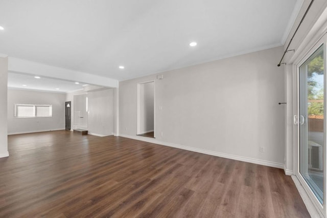 unfurnished living room with recessed lighting, dark wood-type flooring, baseboards, and ornamental molding