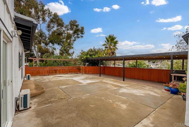 view of patio / terrace featuring ac unit and fence