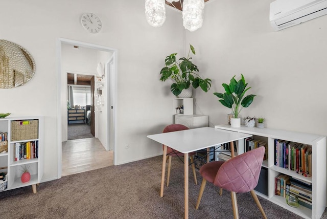 dining room featuring a wall mounted air conditioner, carpet, and a chandelier