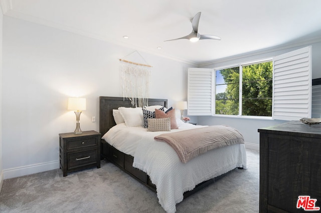 bedroom with ceiling fan, crown molding, and light carpet