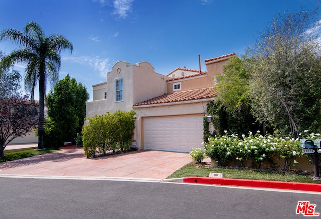 mediterranean / spanish-style house with a garage