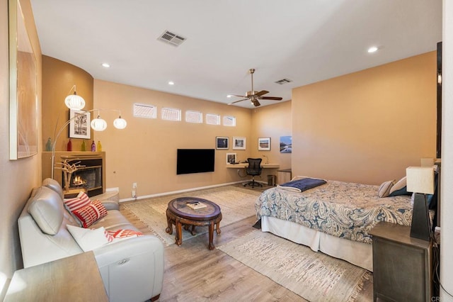 bedroom with ceiling fan and light hardwood / wood-style floors