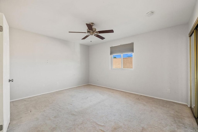 unfurnished bedroom with ceiling fan and light carpet