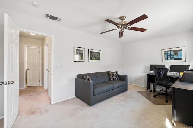 carpeted office space with ceiling fan