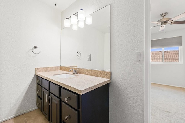 bathroom with ceiling fan, tile patterned flooring, and vanity