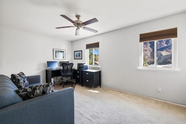 carpeted office featuring ceiling fan