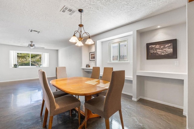 dining space with ceiling fan with notable chandelier and a textured ceiling