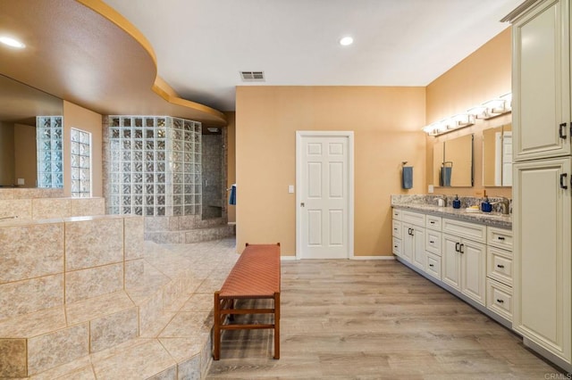 bathroom with hardwood / wood-style floors and vanity