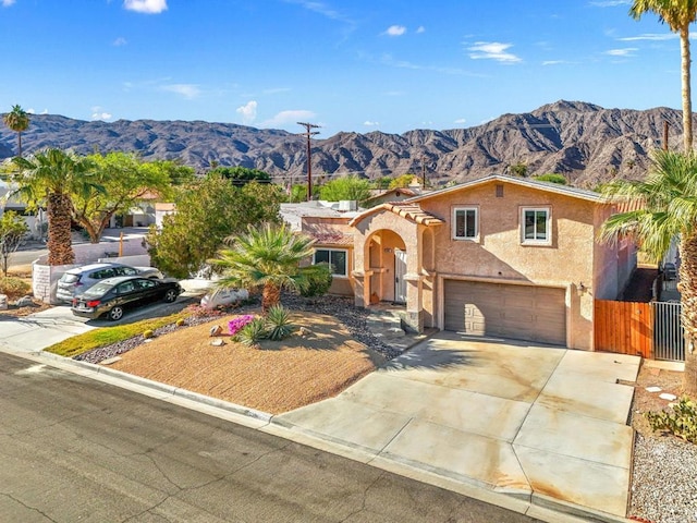 view of front of home featuring a mountain view and a garage