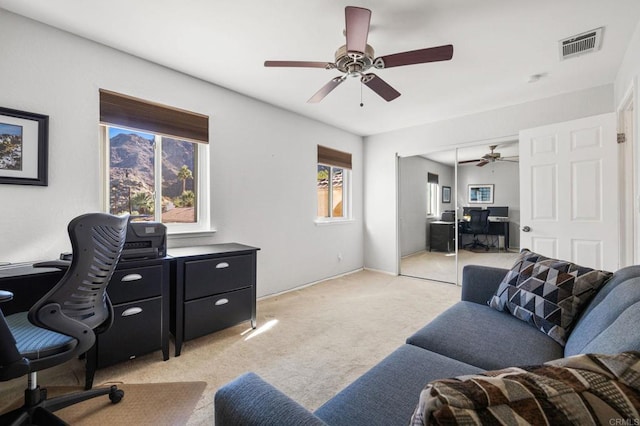 office featuring light carpet and ceiling fan