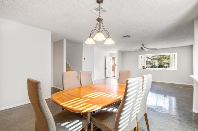 dining space featuring ceiling fan with notable chandelier and a textured ceiling