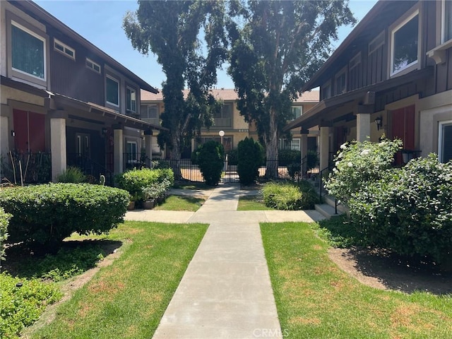 view of home's community with a lawn