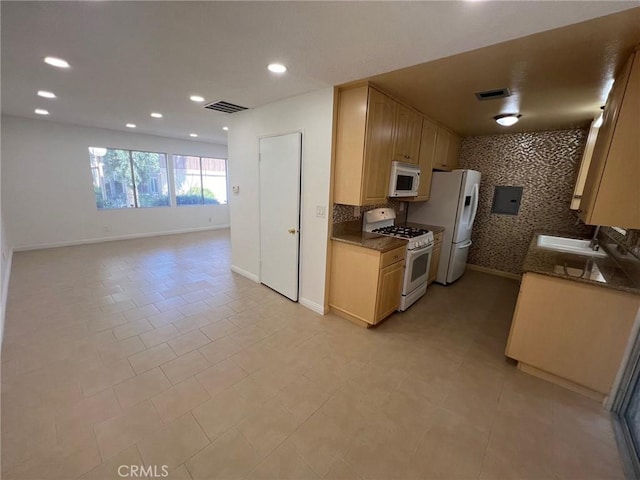 kitchen featuring light brown cabinetry, white appliances, electric panel, and light tile patterned floors