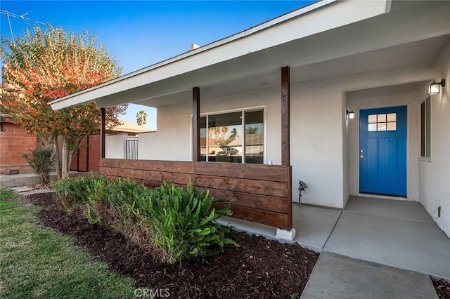 entrance to property featuring a porch