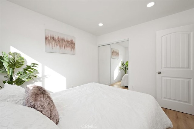 bedroom featuring hardwood / wood-style floors and a closet