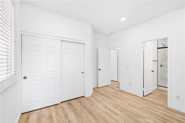 unfurnished bedroom featuring a closet and light hardwood / wood-style flooring