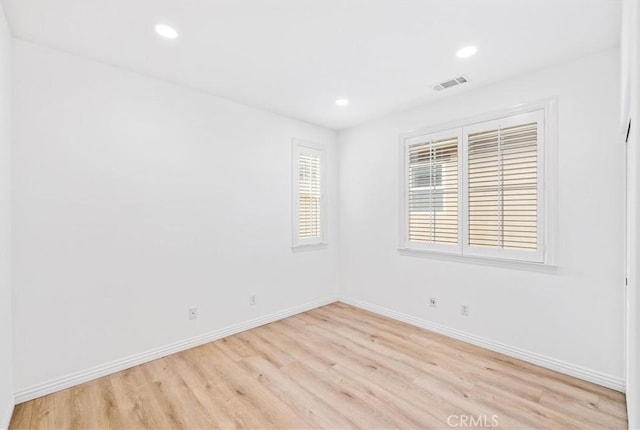 spare room with light hardwood / wood-style floors