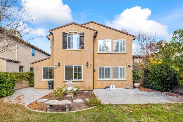 back of property featuring a patio area