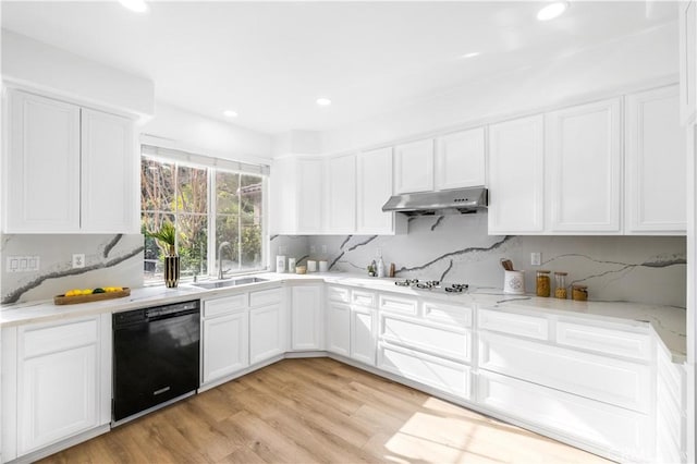 kitchen with black dishwasher, backsplash, light wood-type flooring, white cabinets, and sink