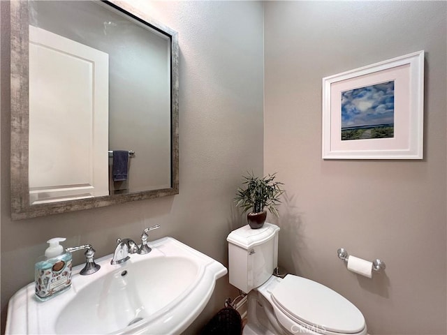 bathroom featuring toilet and sink