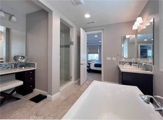 bathroom with vanity, an enclosed shower, and tasteful backsplash