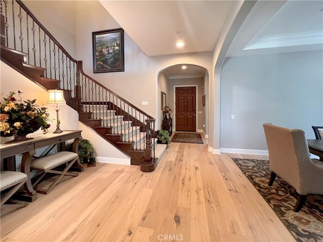 entrance foyer featuring light hardwood / wood-style floors and ornamental molding