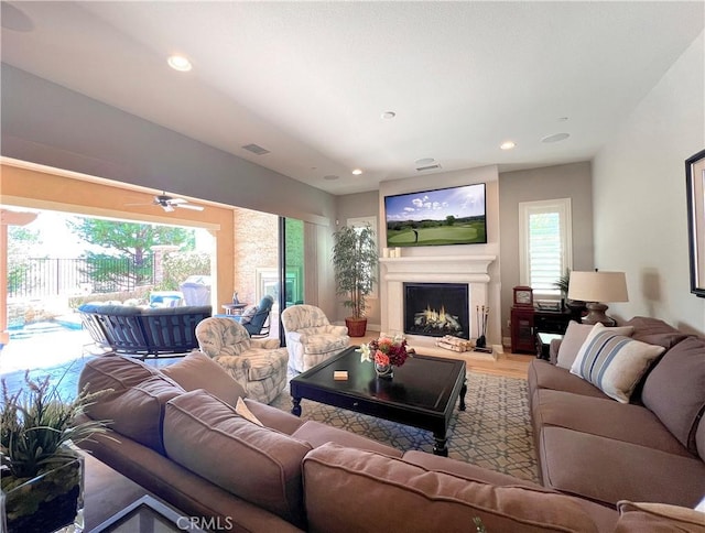 living room with ceiling fan, a healthy amount of sunlight, and wood-type flooring