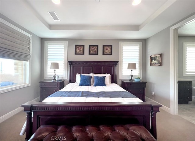 bedroom featuring light carpet and multiple windows