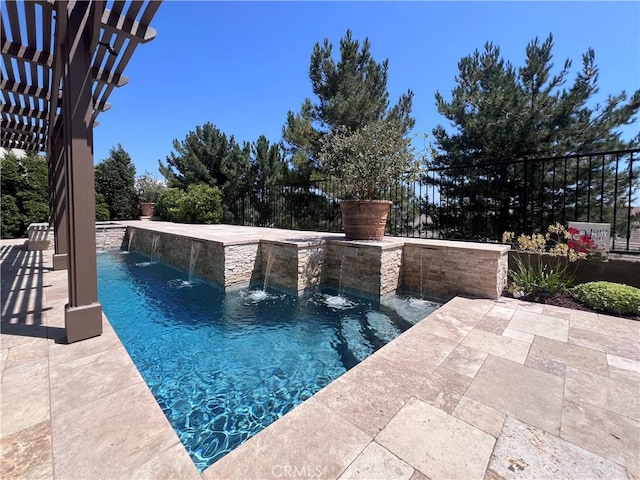 view of pool with pool water feature, a patio, and a pergola